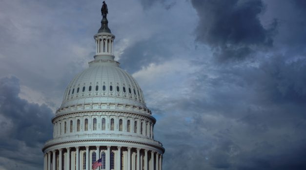 Close up of the US capitol building dome with gathering storm clouds. Concept of political and social turmoil coming.